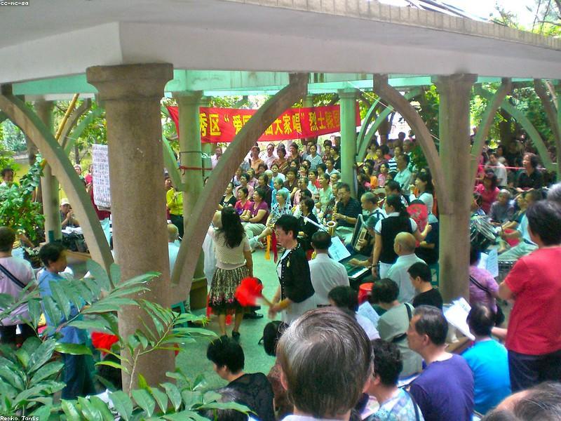 Chinese retirees square dancing in a public park at sunset