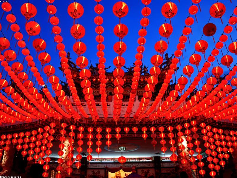 Paper offerings and incense burning at a Chinese temple during Ghost Festival
