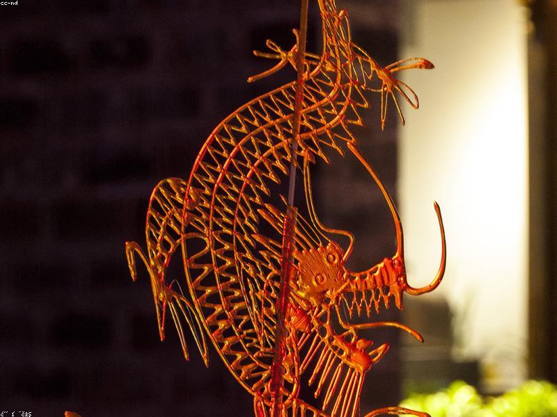 Red lanterns and spring festival decorations hanging across a traditional Chinese street