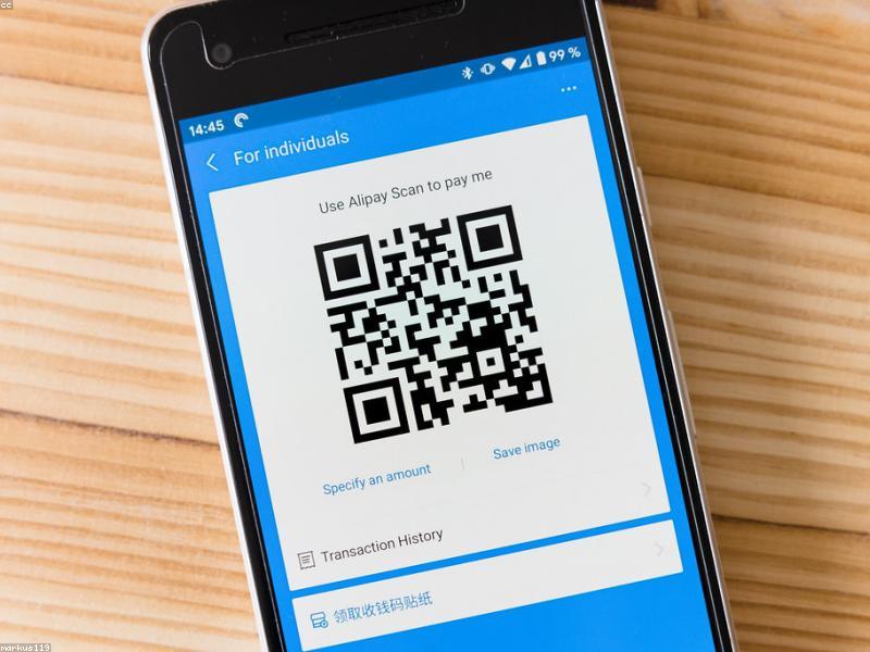 Smartphone showing payment QR code at a market