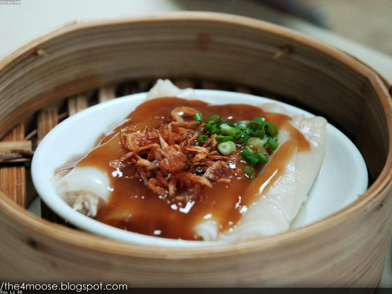 Bamboo steamers stacked with dim sum including har gow and siu mai
