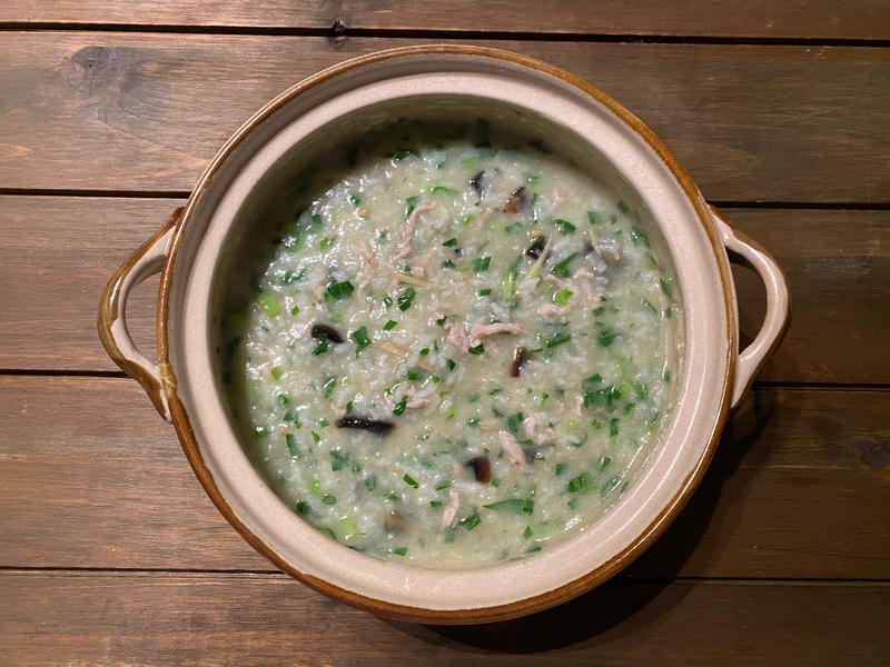 Bowl of congee with century egg and pork