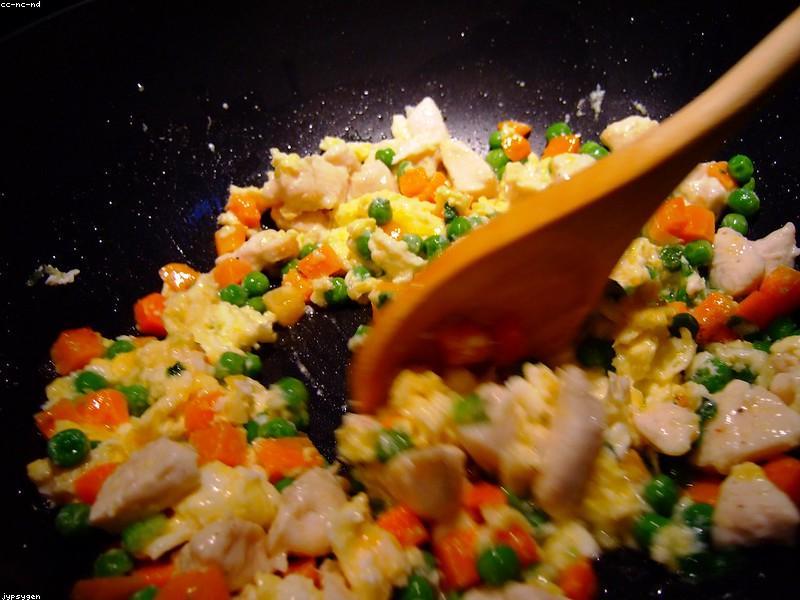 Wok with flames and stir-fry ingredients