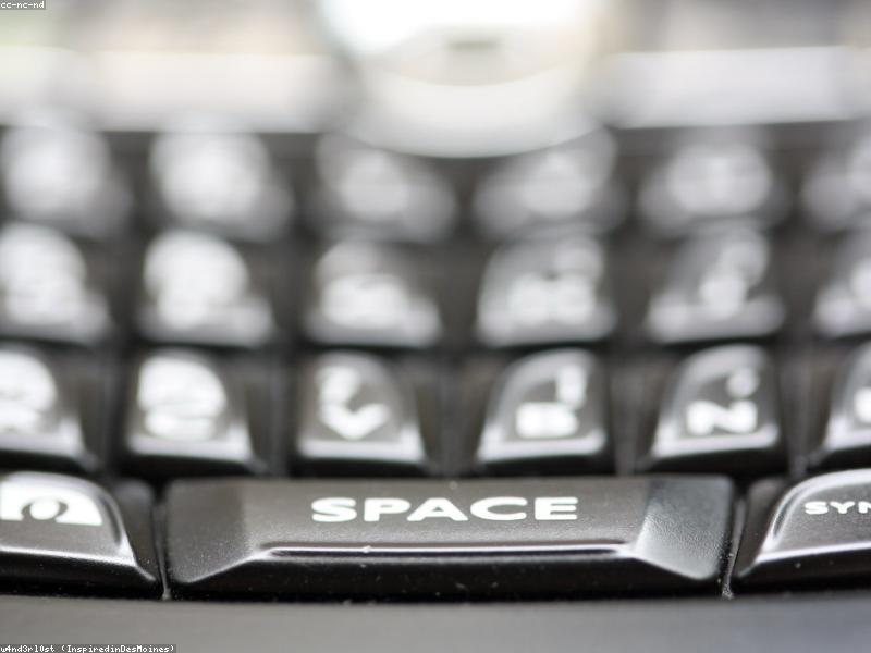 Person typing Chinese characters on a laptop keyboard