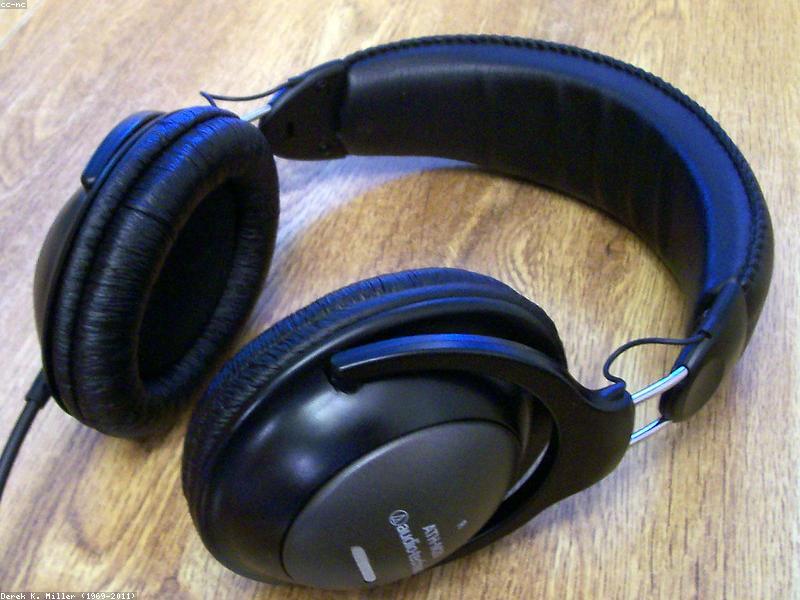 Person wearing headphones listening to a podcast while commuting
