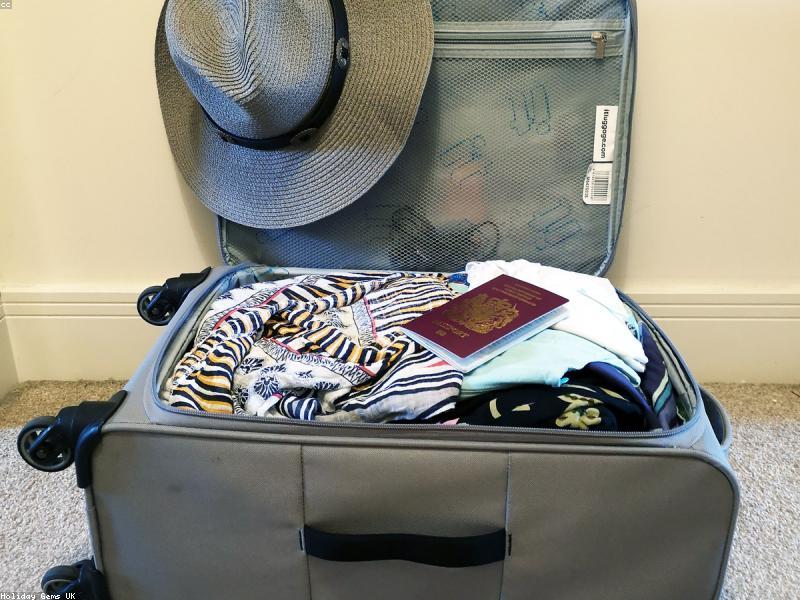Travel packing flat lay with passport and essentials